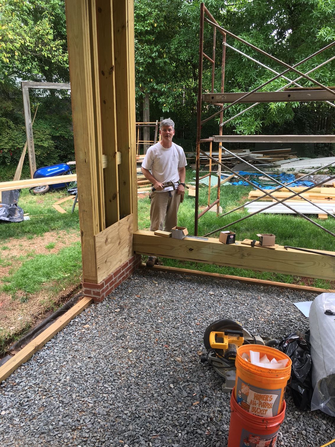 a man is standing in a room with a scaffolding in the background .