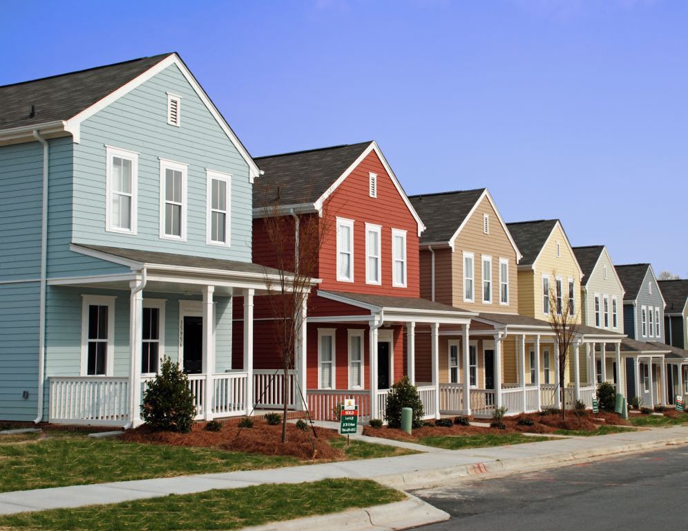 a row of houses with porches in a residential neighborhood