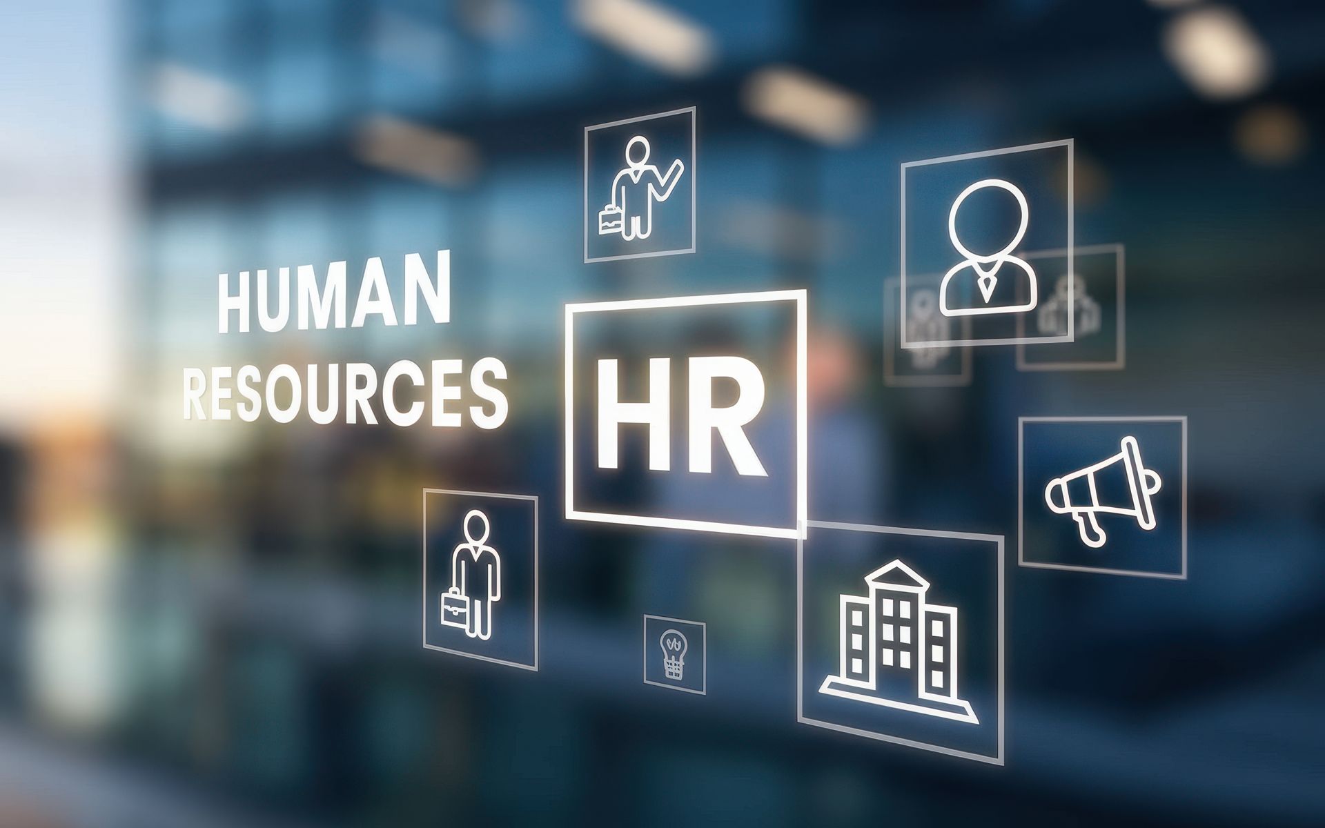 A blurred image of a glass wall with the words human resources hr written on it.