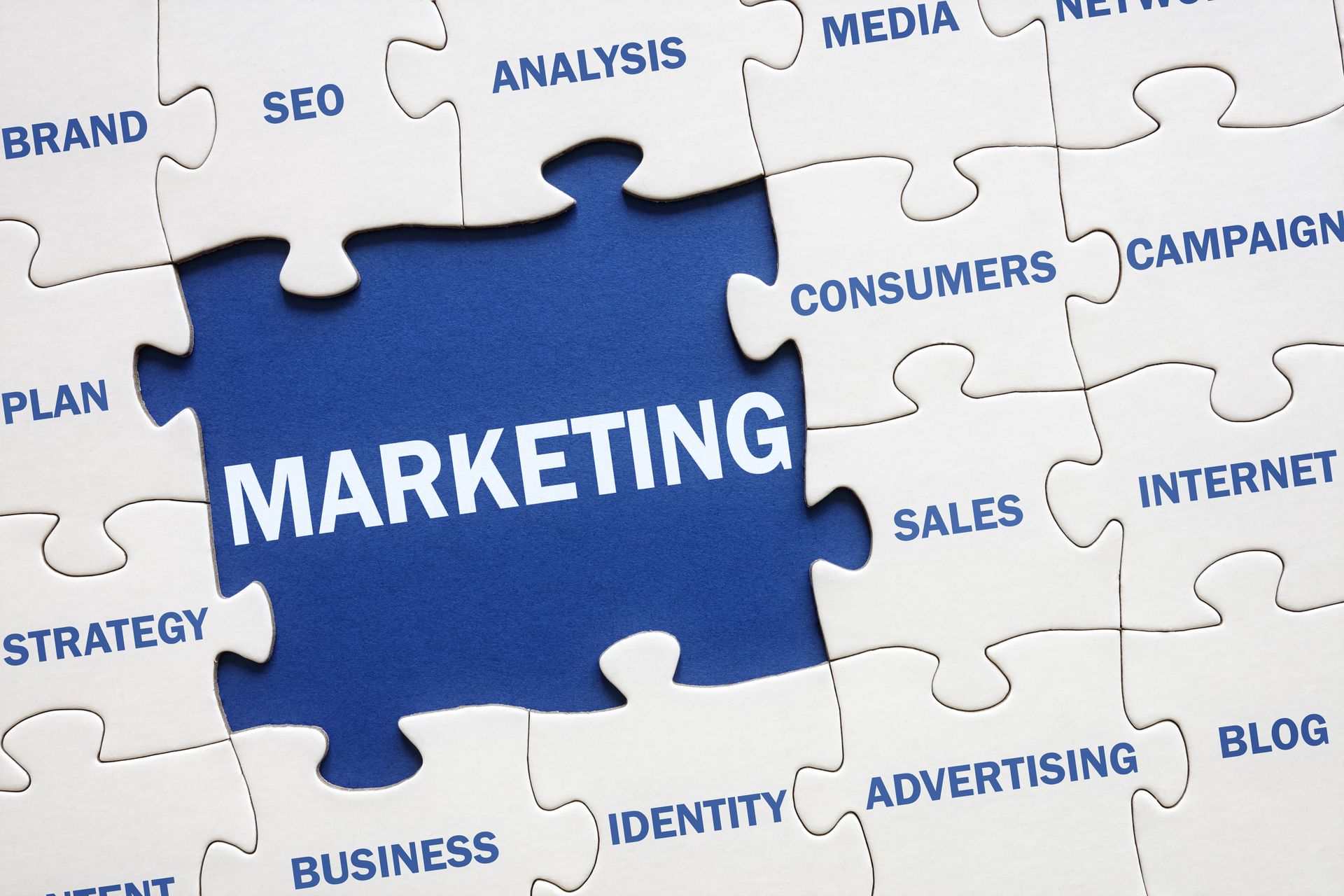 A blue puzzle piece with the word marketing on it