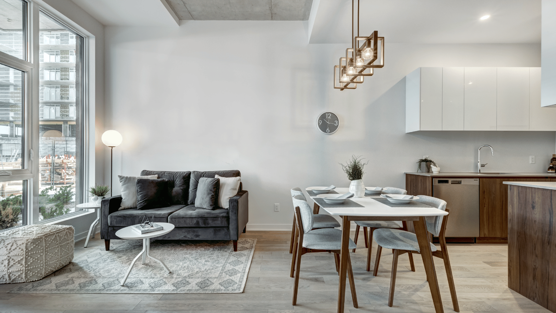 Man in gloves and safety glasses repairs water heater in a room.