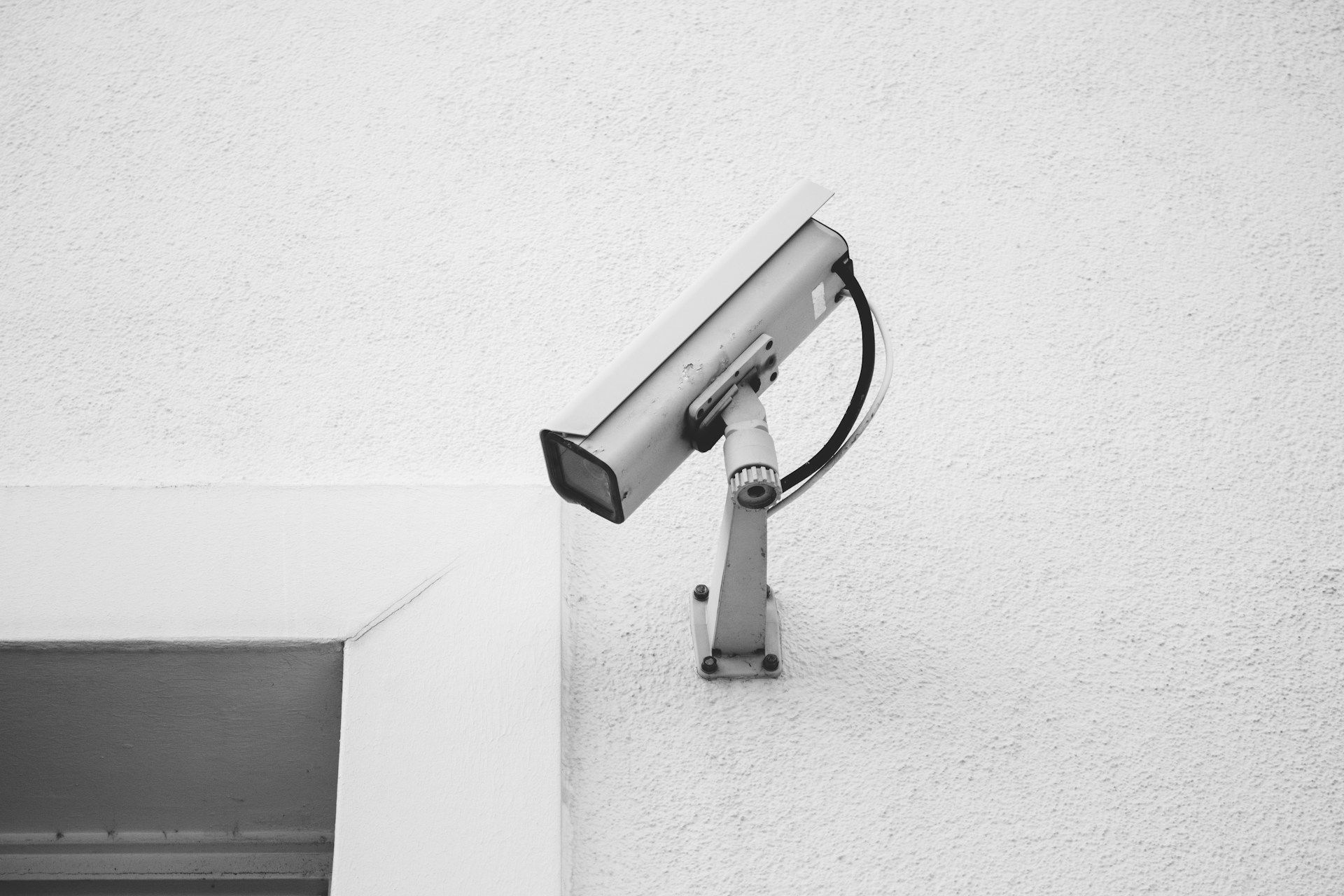 A CCTV camera attached to a white wall