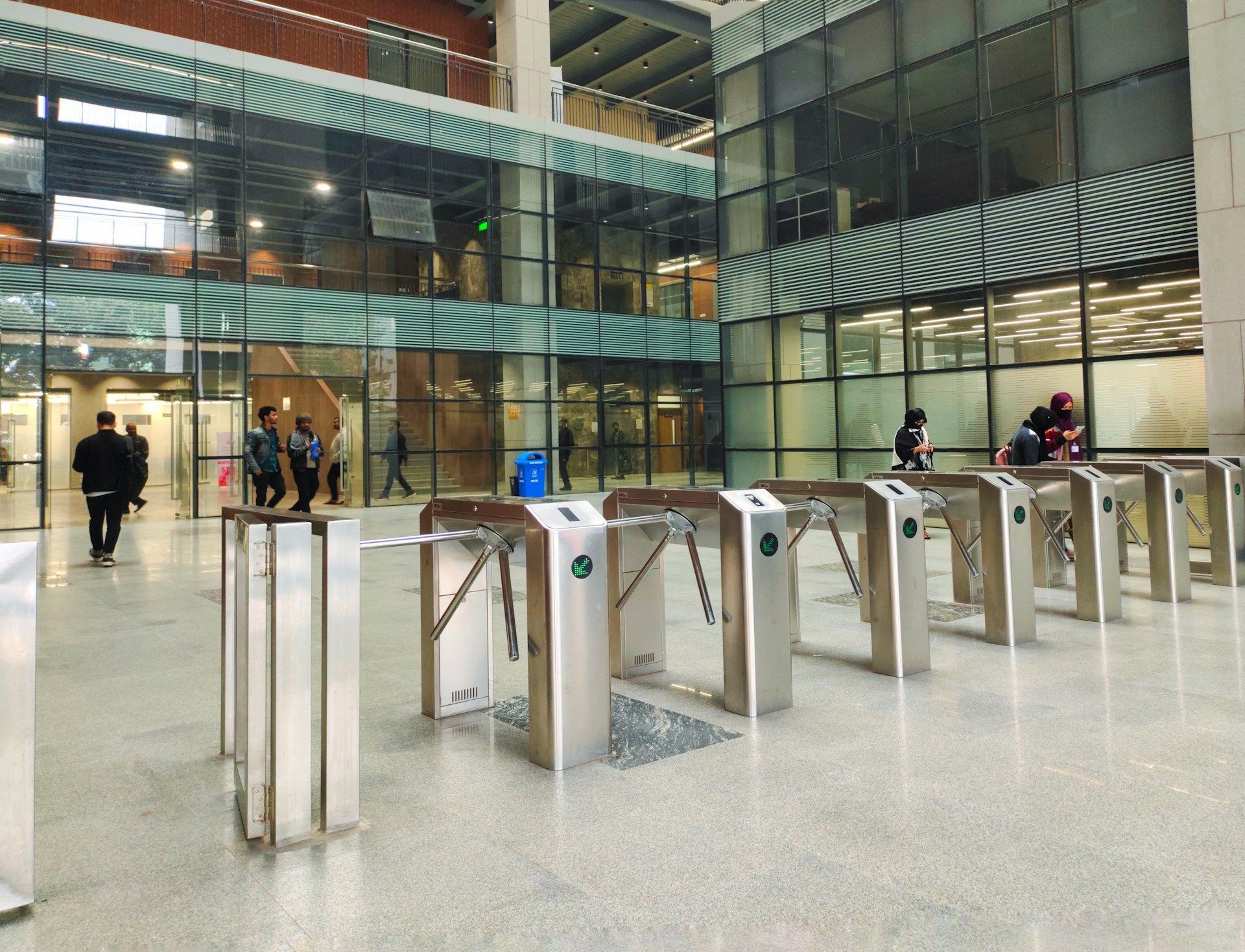 A row of Turnstiles outside a modern building