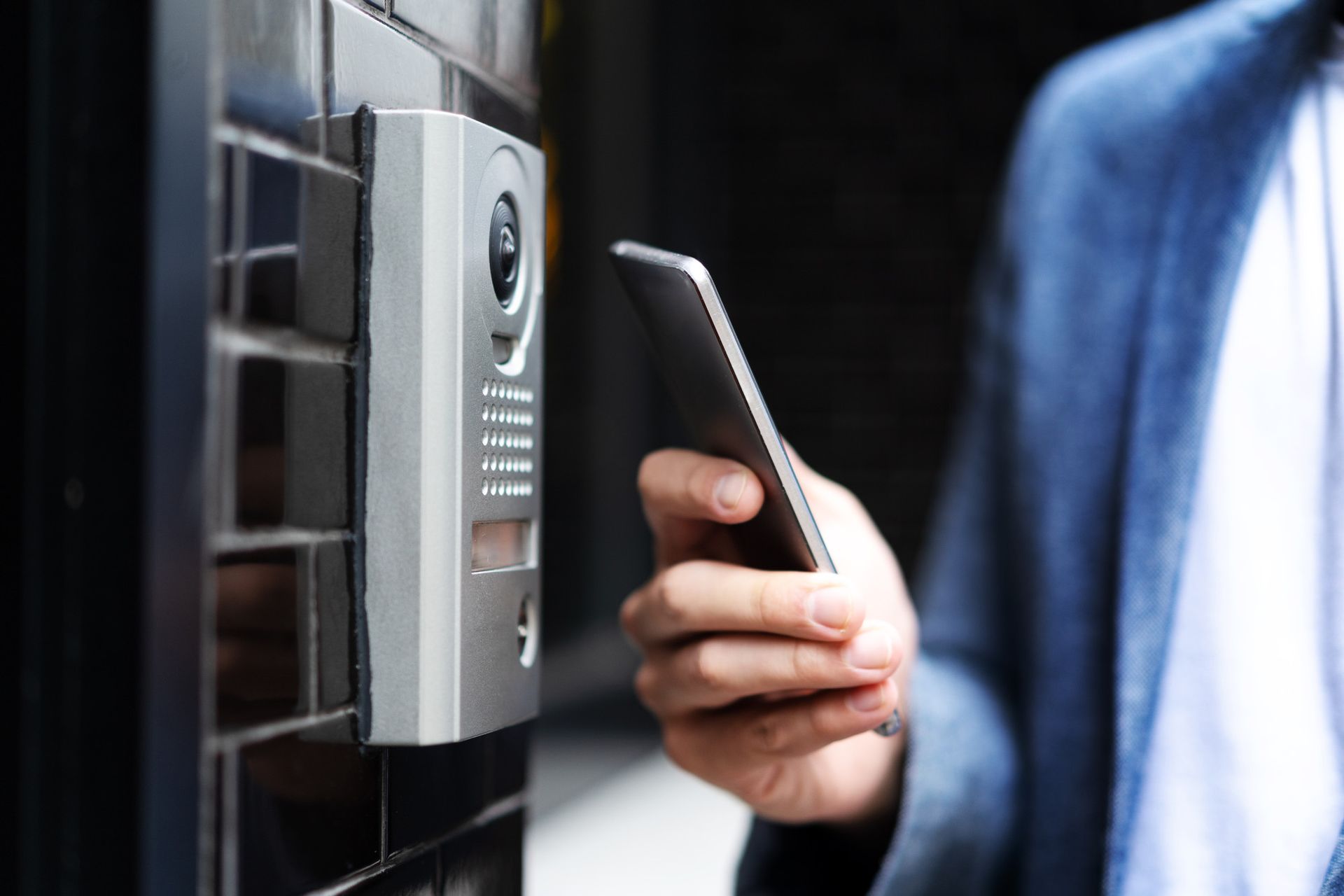 A man using an access control system to get inside a building