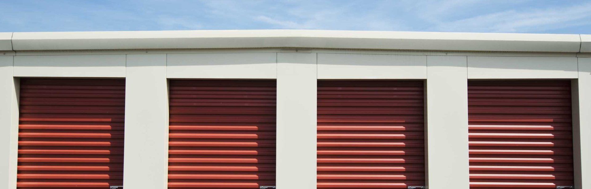 A row of red roller security shutters