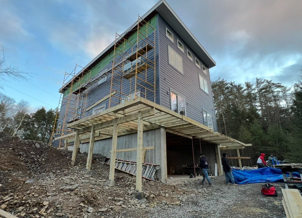 A house is being built on a hill with scaffolding around it.