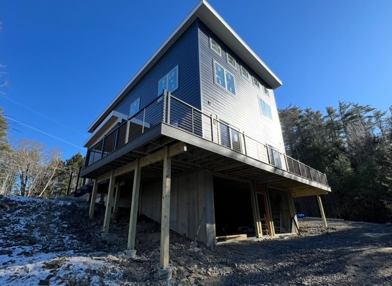 A large house with a large deck on top of it