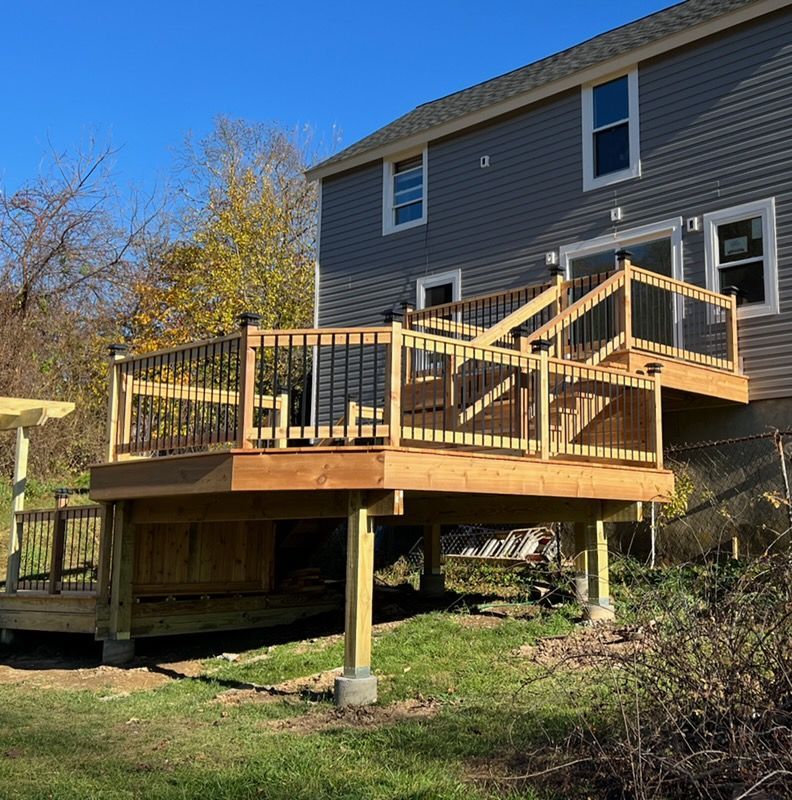 A large house with a wooden deck in front of it