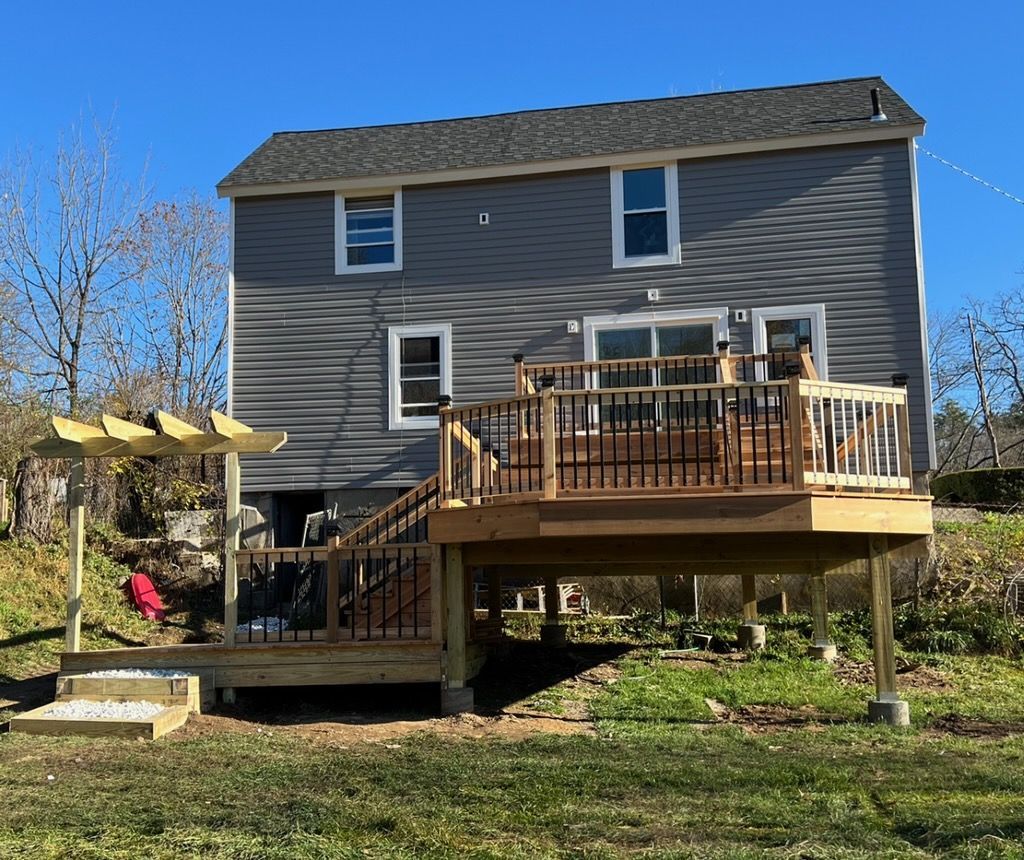 A house with a large deck in front of it