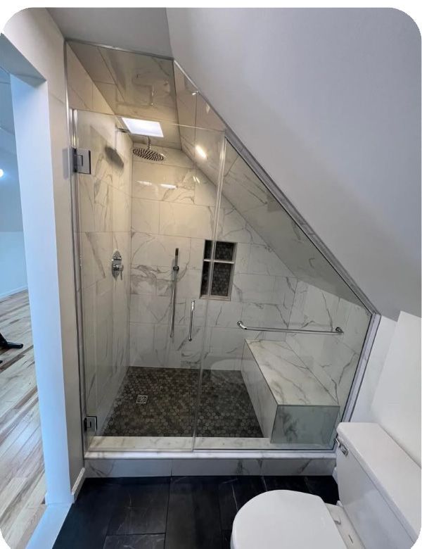 A bathroom with a walk in shower and a toilet