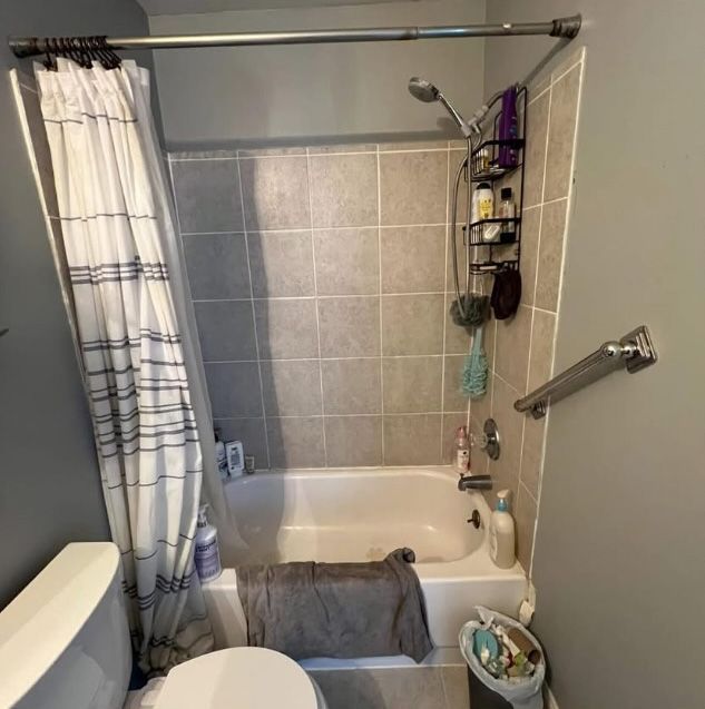 A bathroom with a bathtub toilet and shower