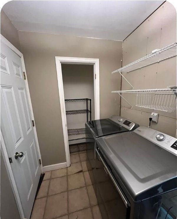 A laundry room with a washer and dryer and a closet.