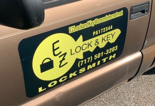 A truck with a sign on the side that says lock & key