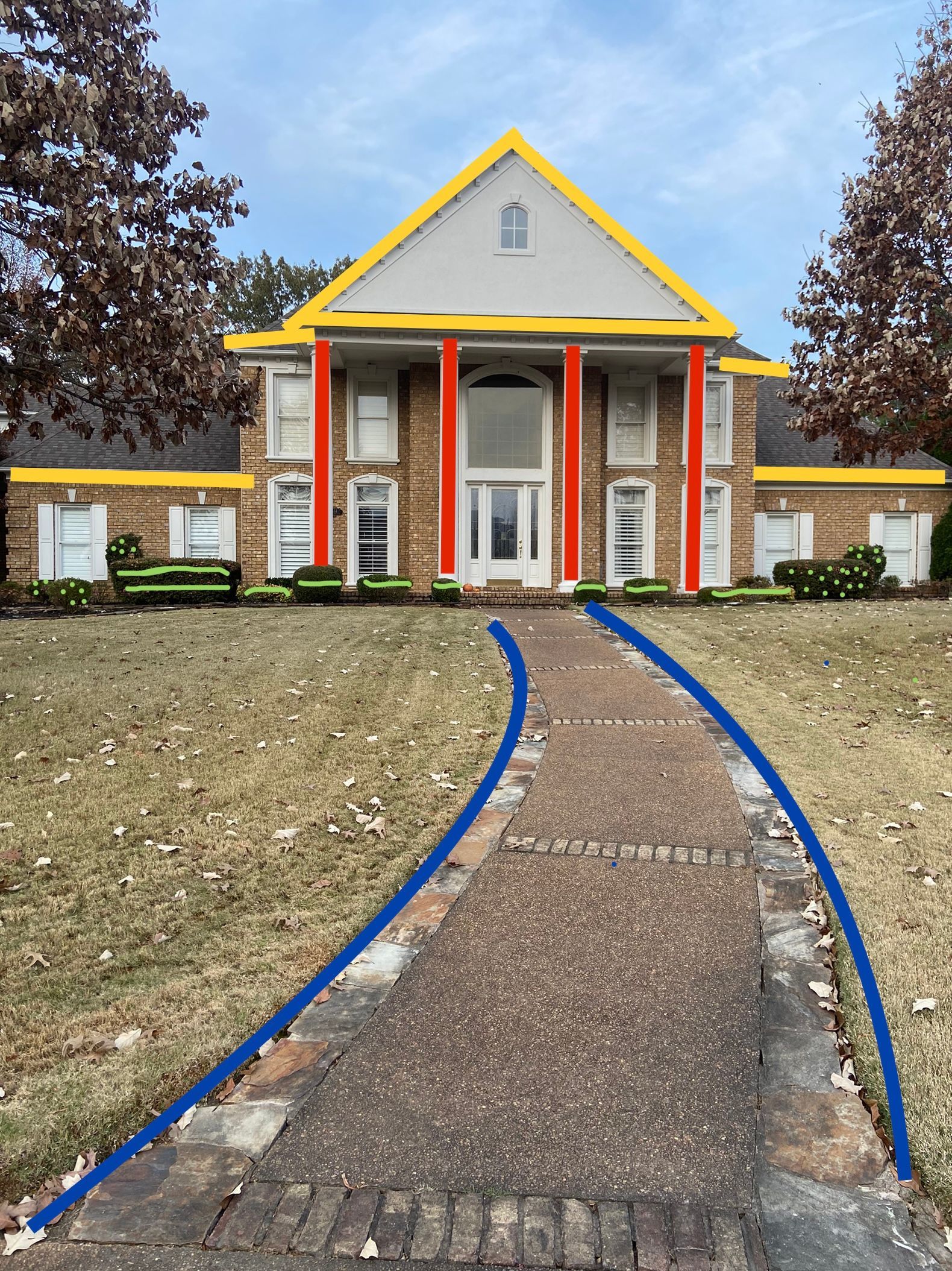 A two-story brick house with yellow trim, red pillars, and a blue pathway leading to the front door.