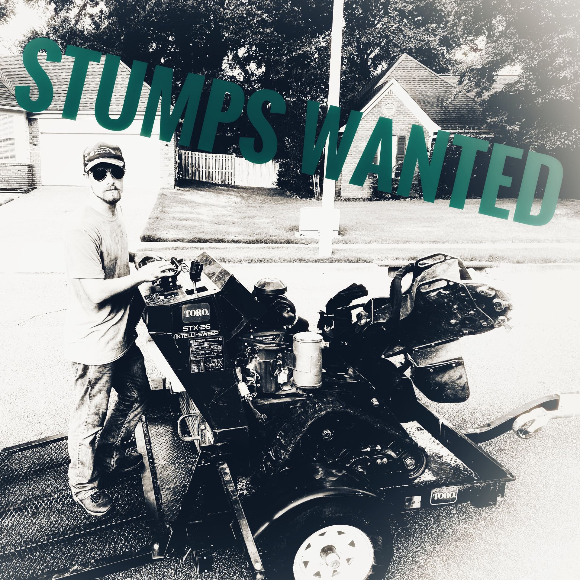 Man standing by a stump grinder trailer with 