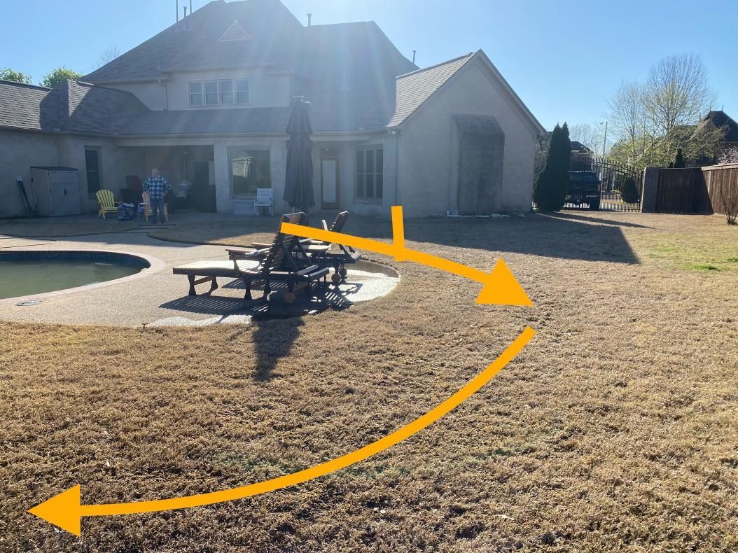 A backyard scene with dry grass, a picnic table, and a house with a pool. An arrow indicates a path through the yard.
