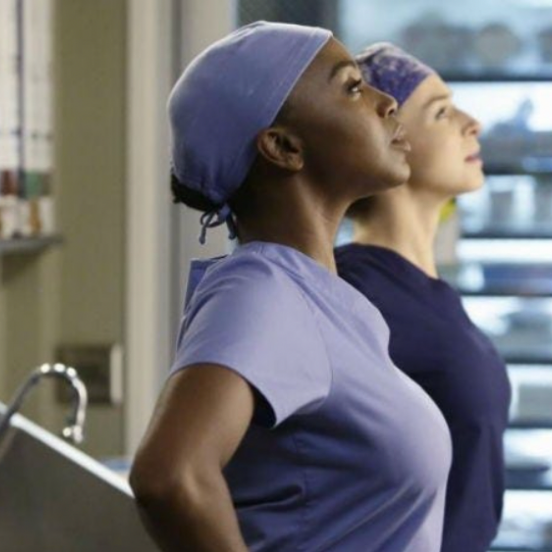 Two women in scrubs are standing next to each other