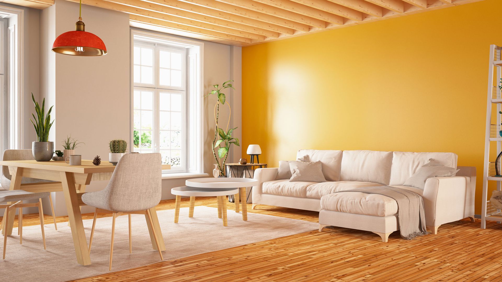 A living room with yellow walls, a white couch, a table and chairs.