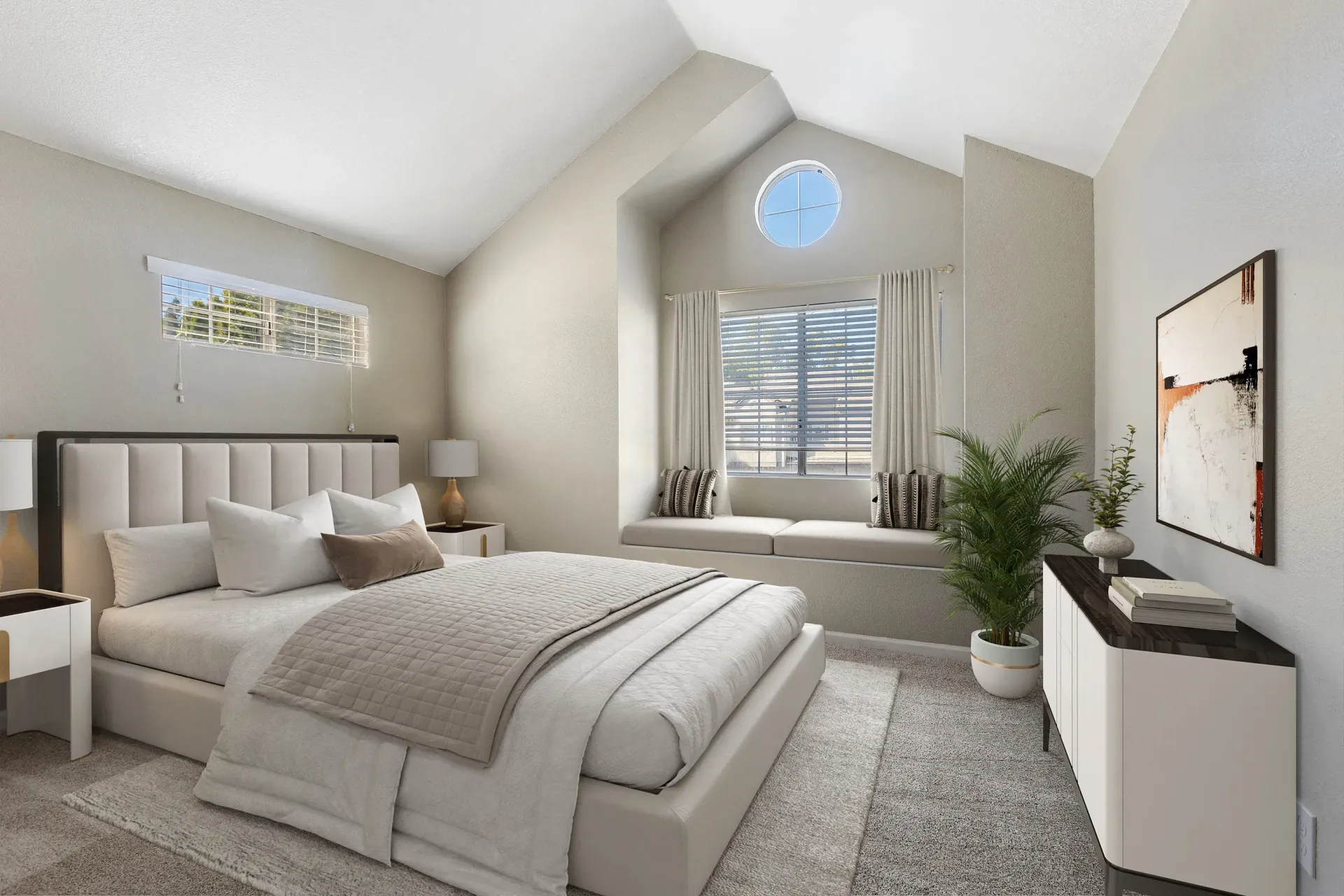 Neutral, modern bedroom with a tufted headboard, two nightstands, and a window seat.