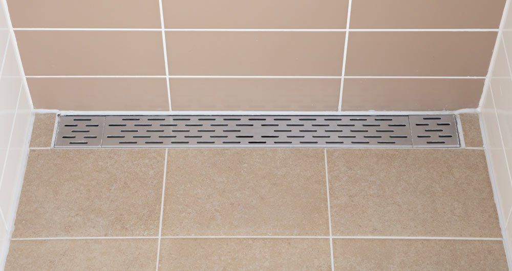 Floor Drain In A Modern Shower — Plumbing And Gas Services In Bundaberg, QLD