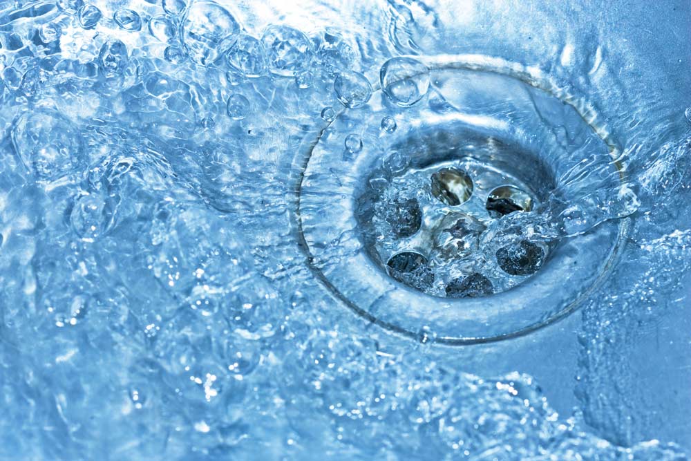 sink drain with water — Plumbing And Gas Services In Bundaberg, QLD