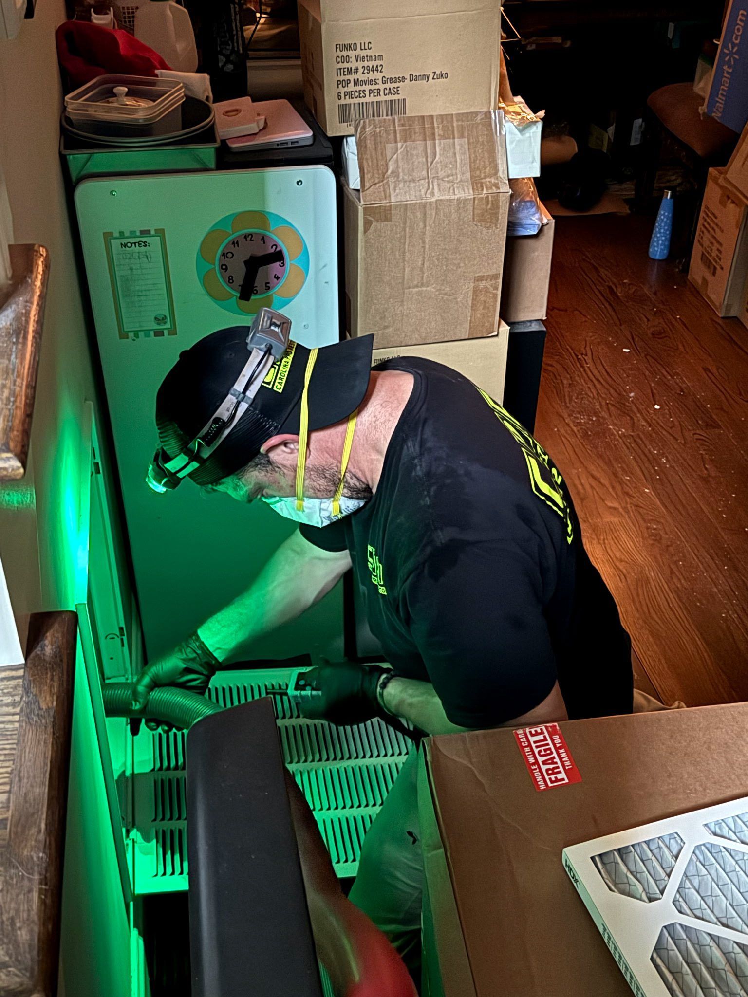 Technician using professional safety equipment during duct cleaning