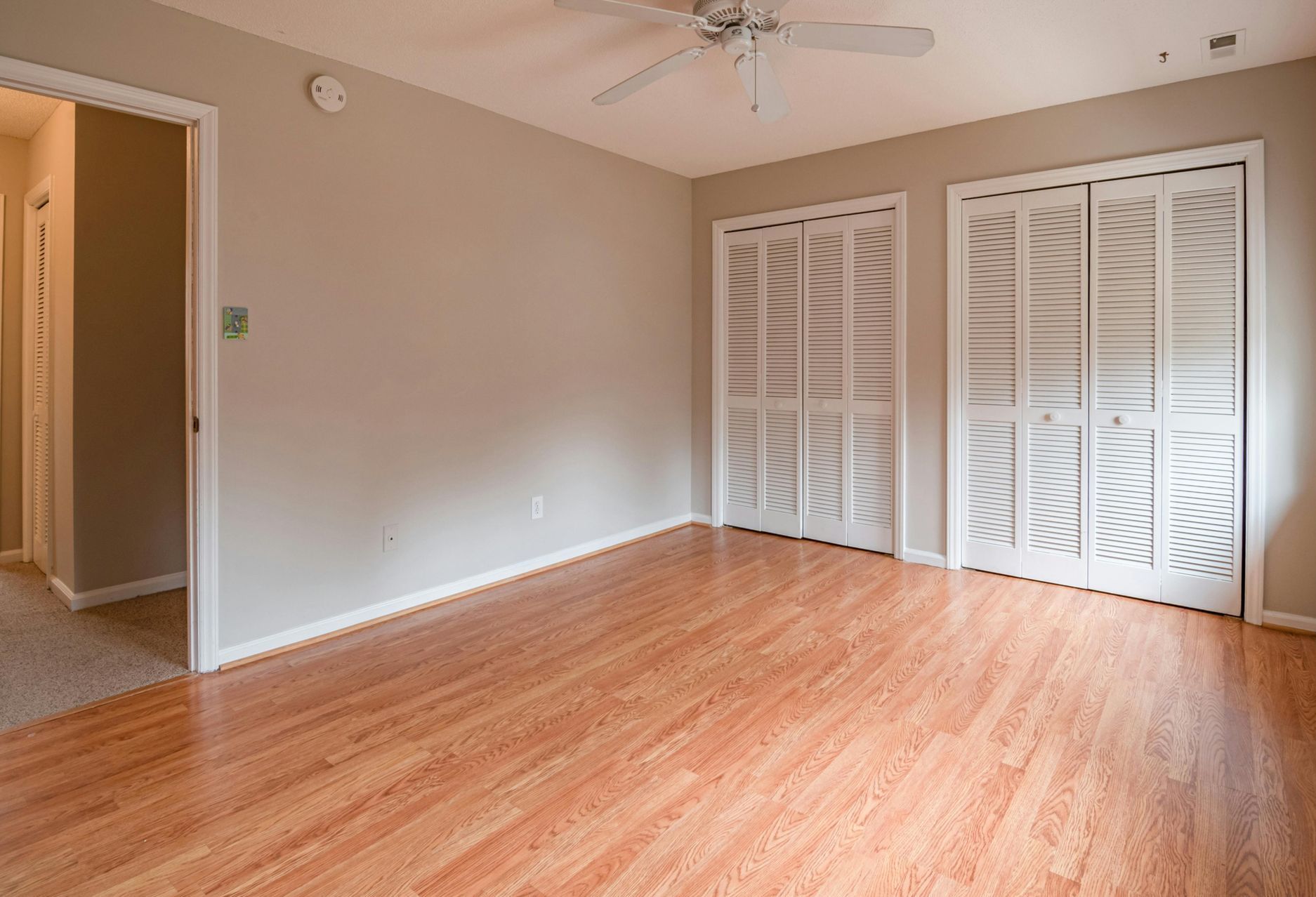 A sink pipe is leaking water under a sink.