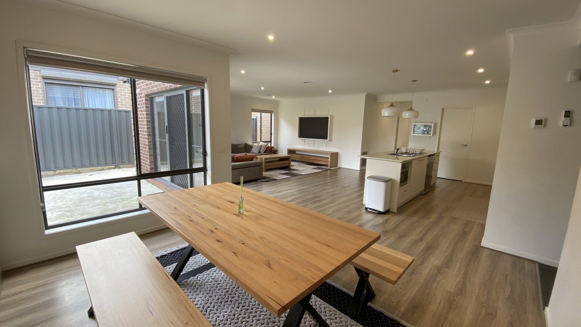 A living room with a wooden table and benches.