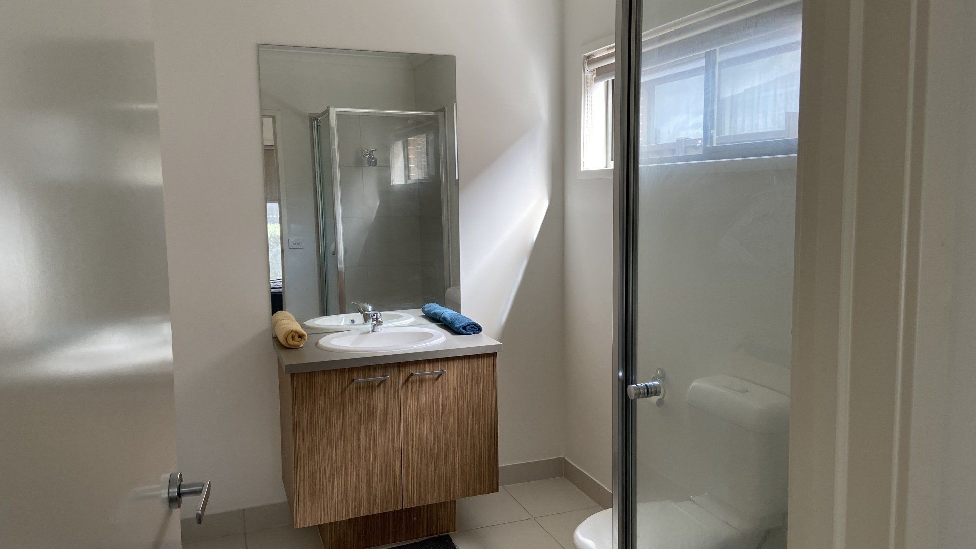 A bathroom with a sink , toilet and shower.