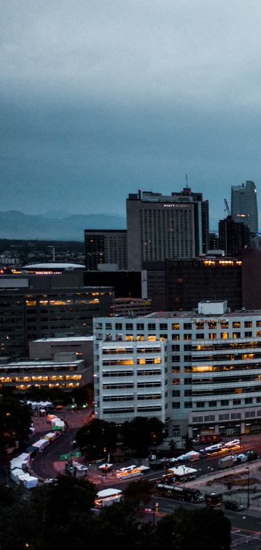 Modern white kitchen with island, wood accents, and gold fixtures.