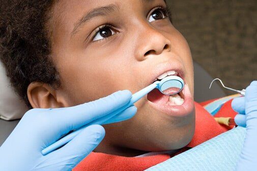 Dentist Checking the Teeth — Dental Care in Cambria Height, NY