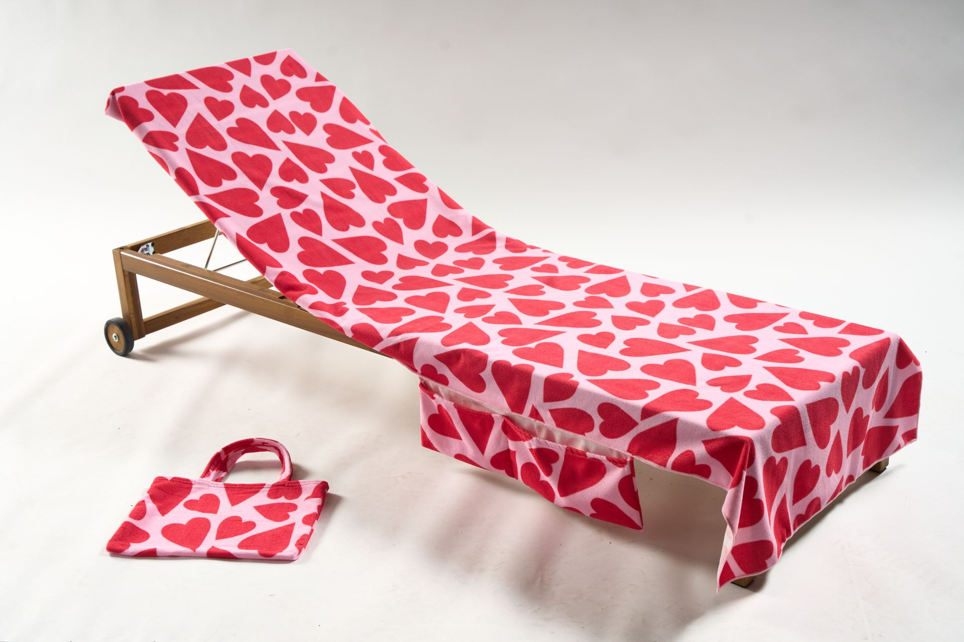 Cut out of beach chair and tote bag with pink and red heart pattern.