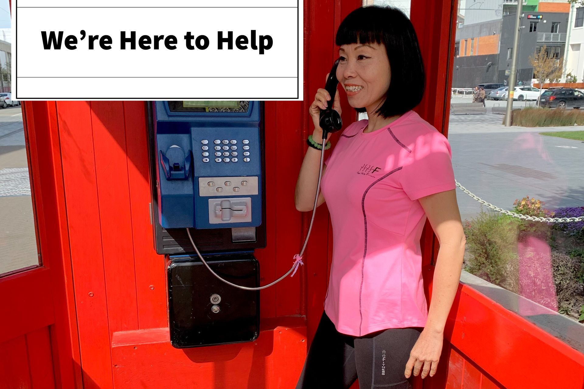 Image of lady making a call from a phone box for assistance