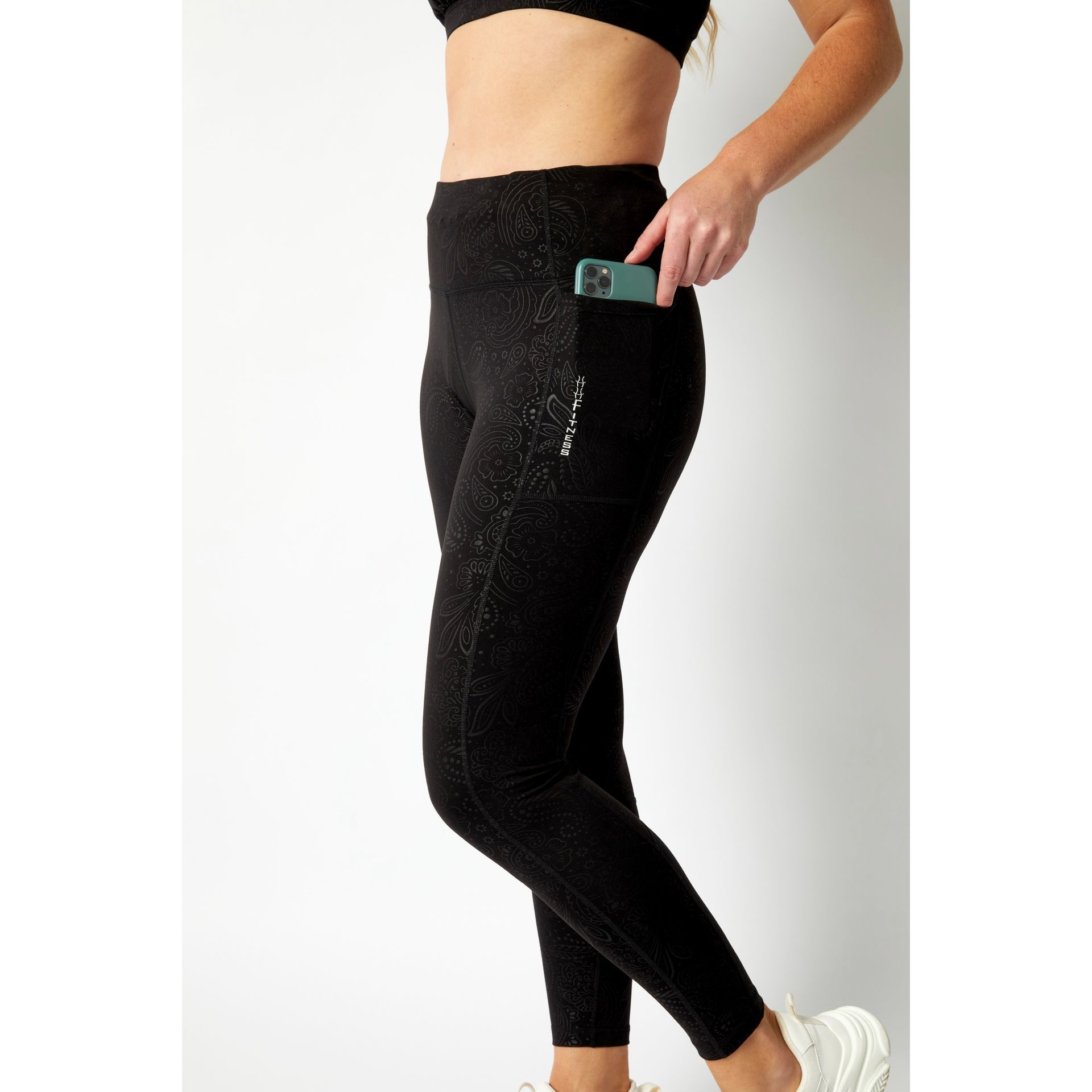 Happy Healthy Fitness leggings on a middle aged lady, show the impressive phone pockets