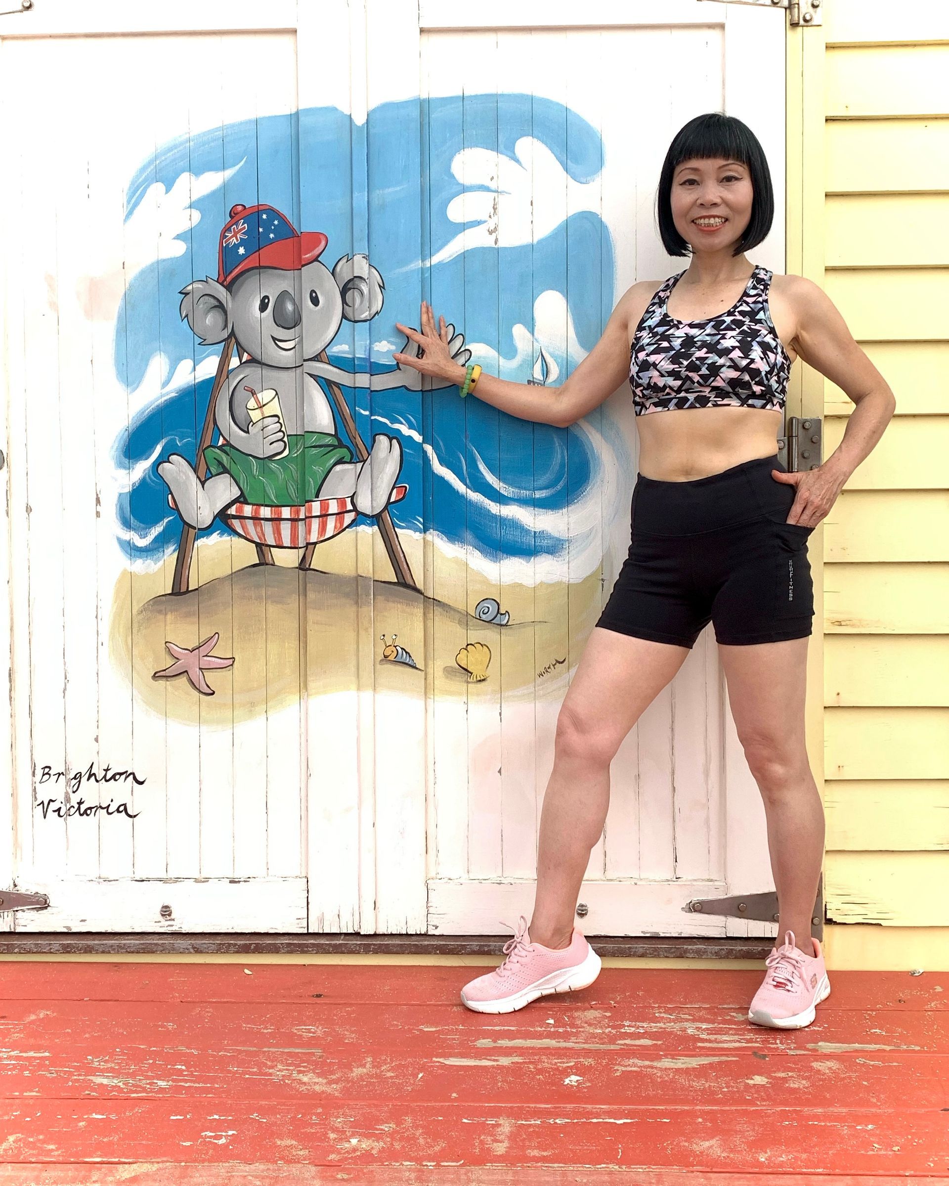 Melbourne Australia image of iconic beach box, with lady in Happy Healthy Fitness activewear.