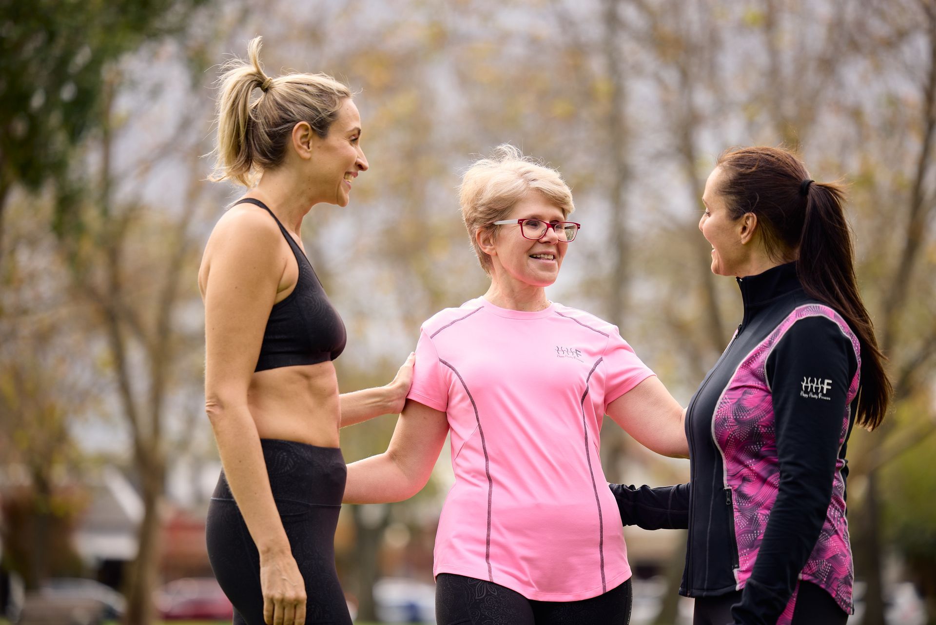 Three ladies - wearing Athleisure and one training in  leggings and bra
