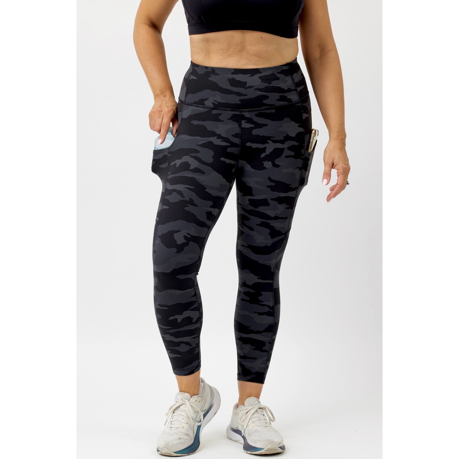 35+ lady wearing beautiful patterned soft feel 7/8 leggings, with drink bottle and phone in the super pockets
