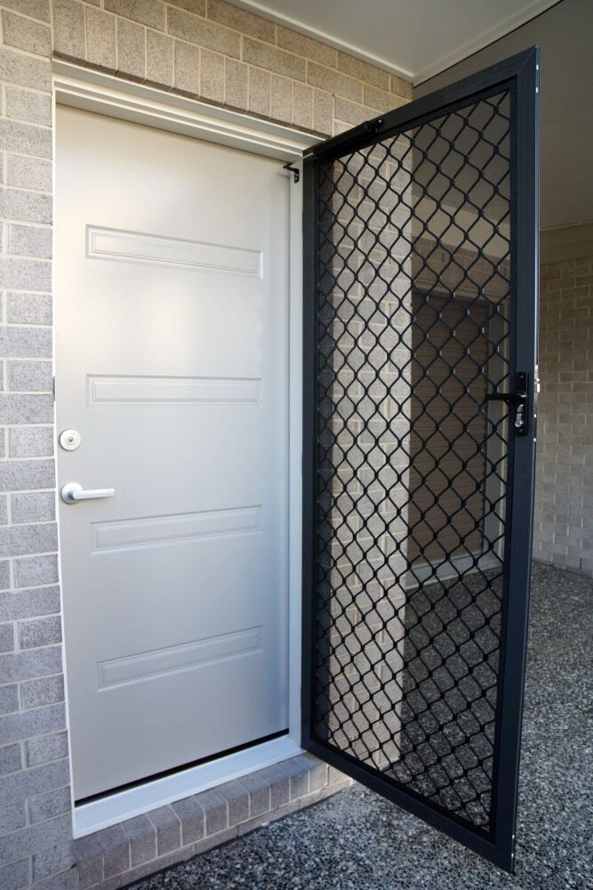 Front Entry with A White Door and An Open Black Security Screen Door on A Brick Porch — Glass Installations & Repairs in Charters Towers, QLD
