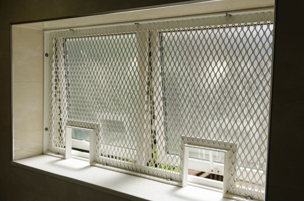 Window with Security Mesh and Two Small White Framed Openings on The Sill — Glass Installations & Repairs in Charters Towers, QLD