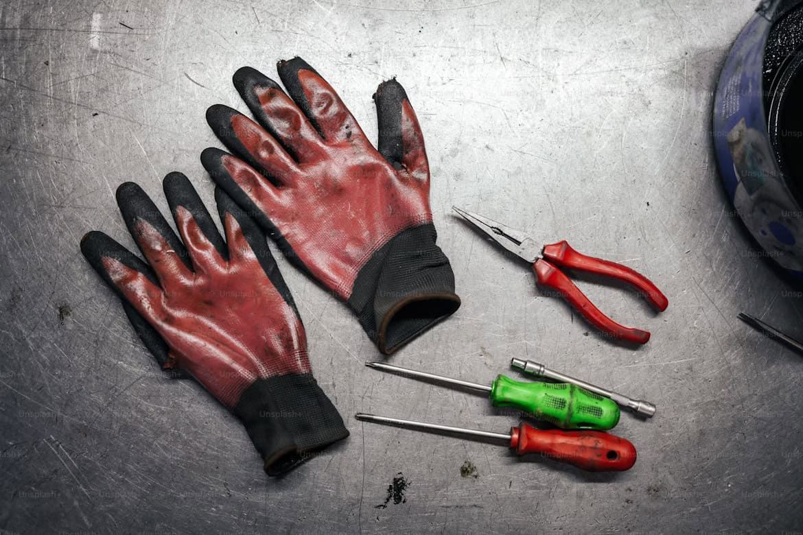 pair of gloves surrounded by tools 