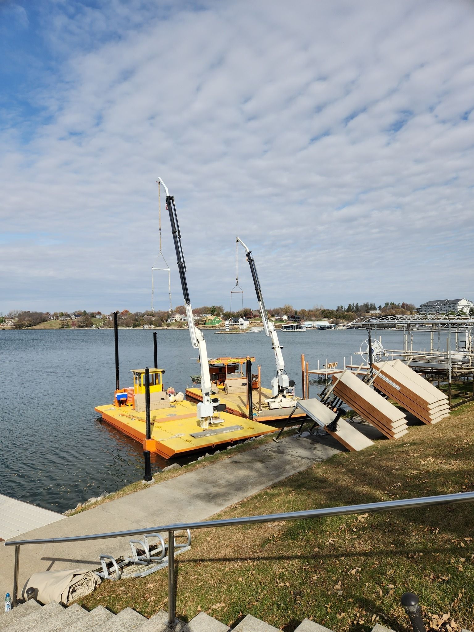 A boat is docked at a dock next to a body of water.