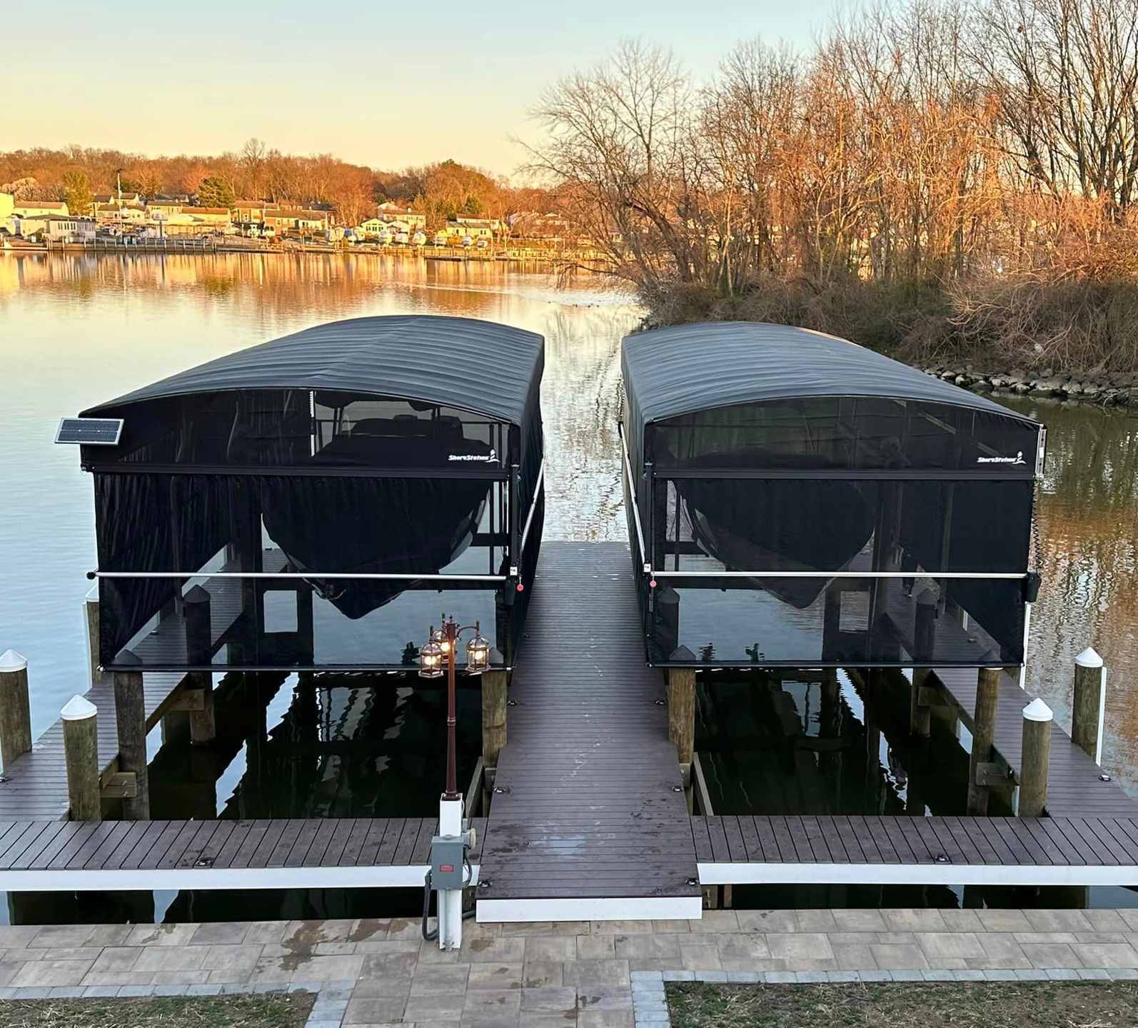 Two boats are docked at a dock on a lake