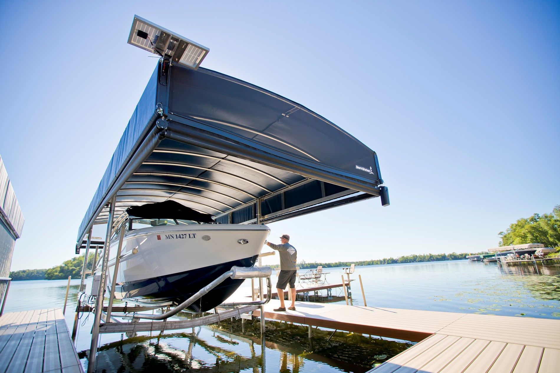 A man is loading a boat into a boat lift.