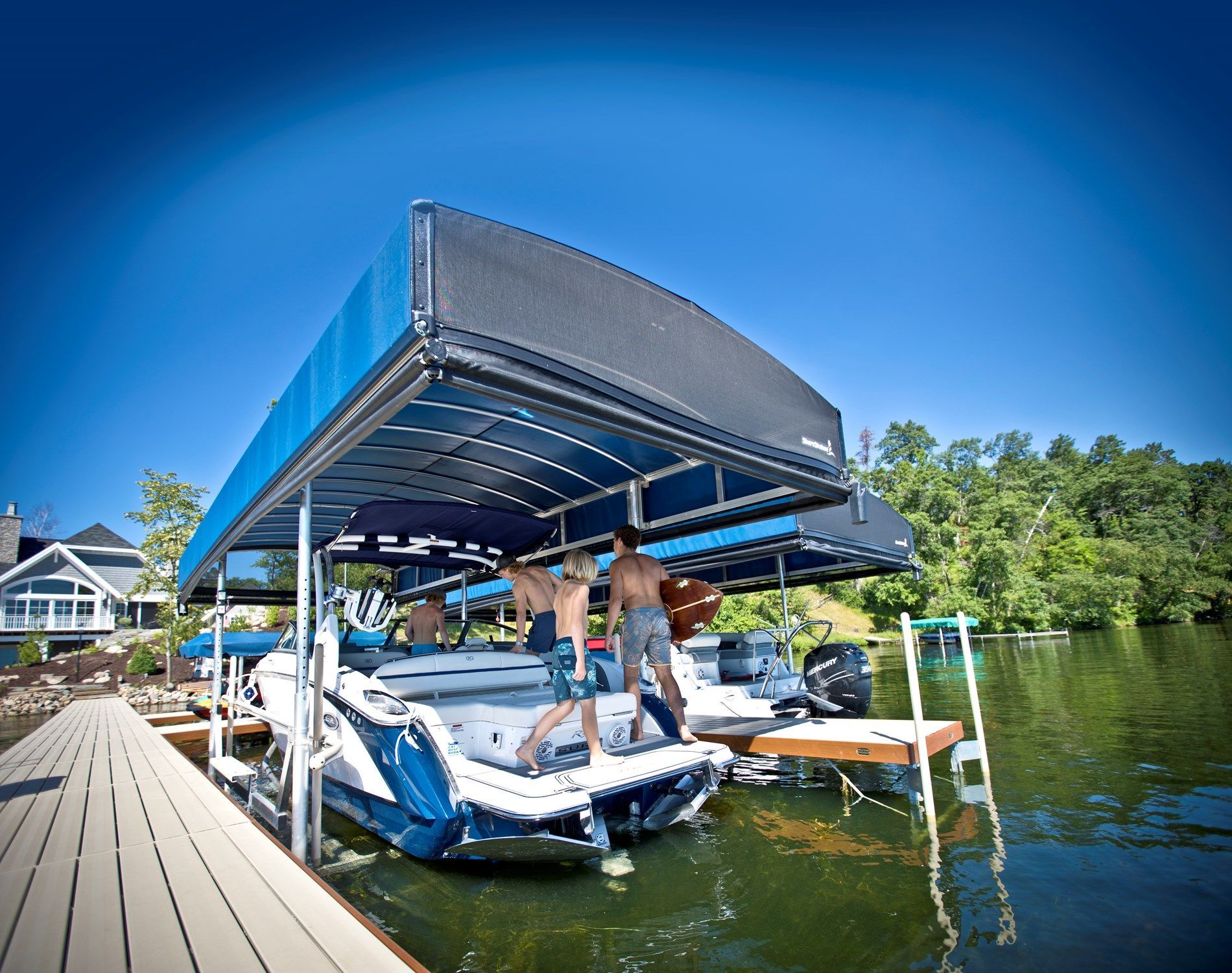 A group of people are standing on top of a boat in a dock.