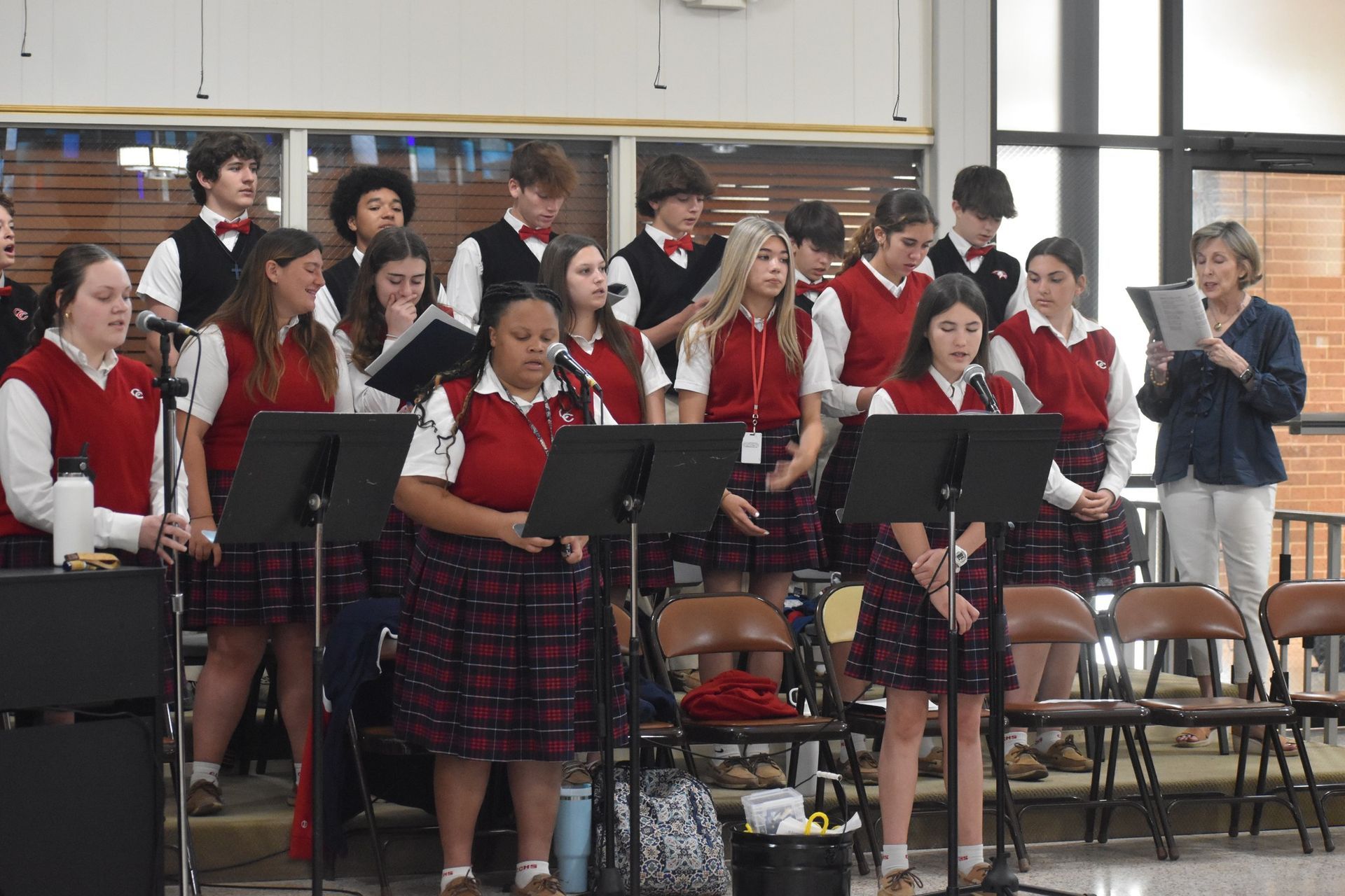 A choir is performing in a school auditorium