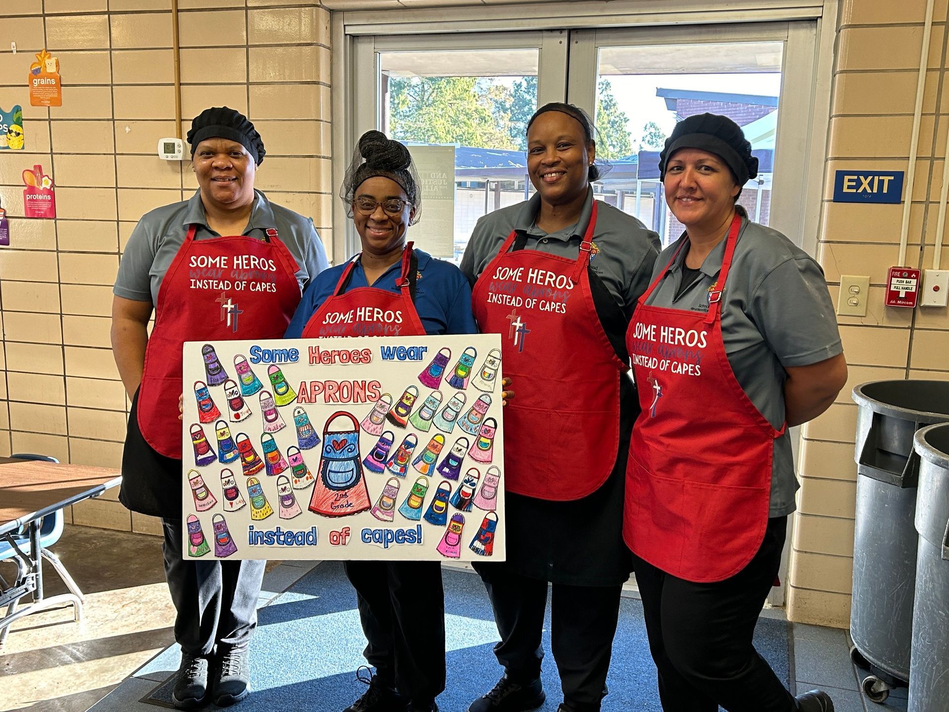 A group of women standing in front of a sign that says game on