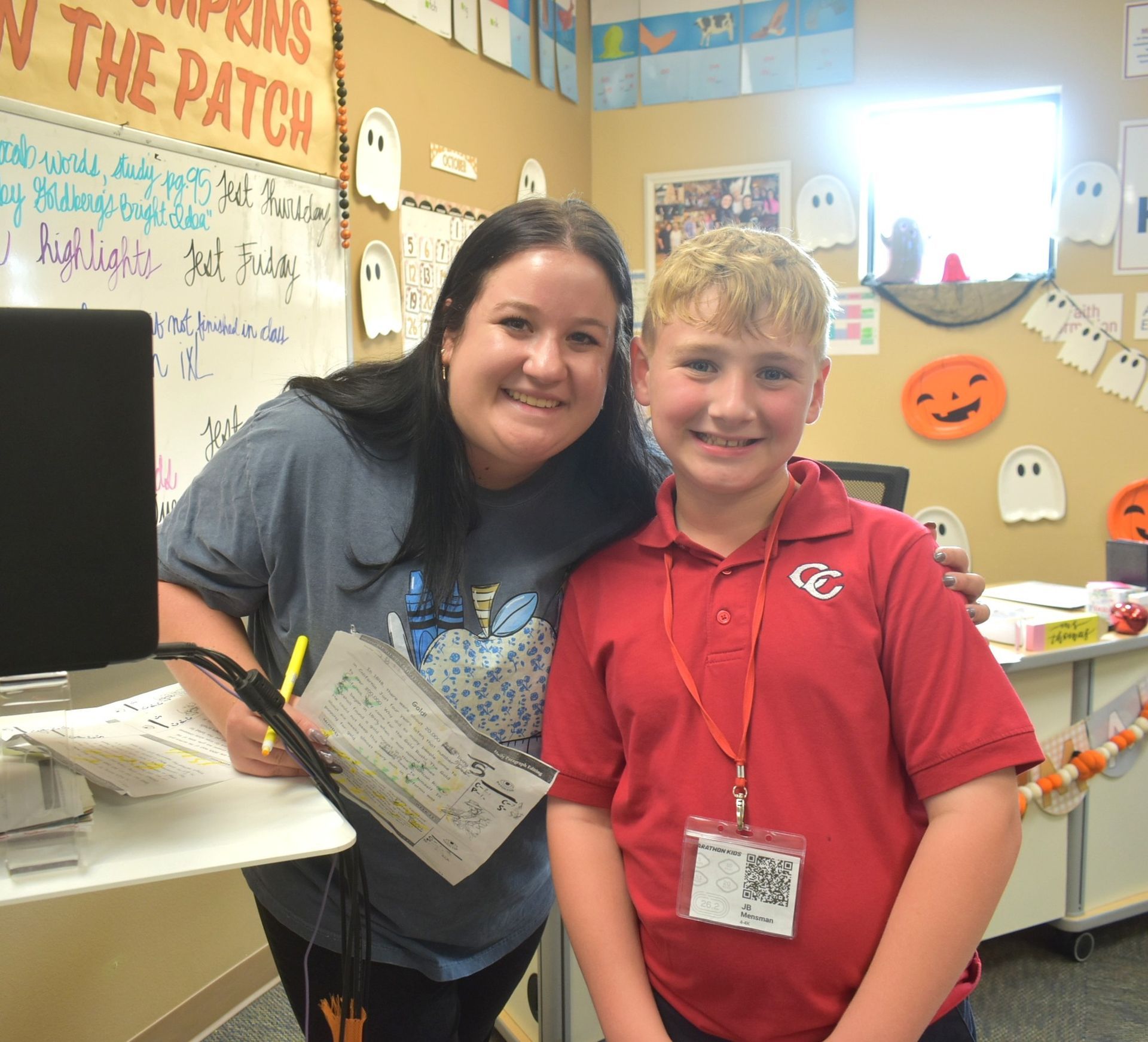 A group of girls in red vests sit in a church