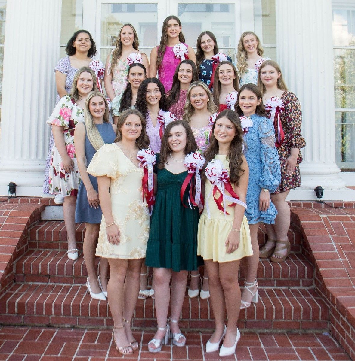 A group of students wearing varsity jackets pose for a picture