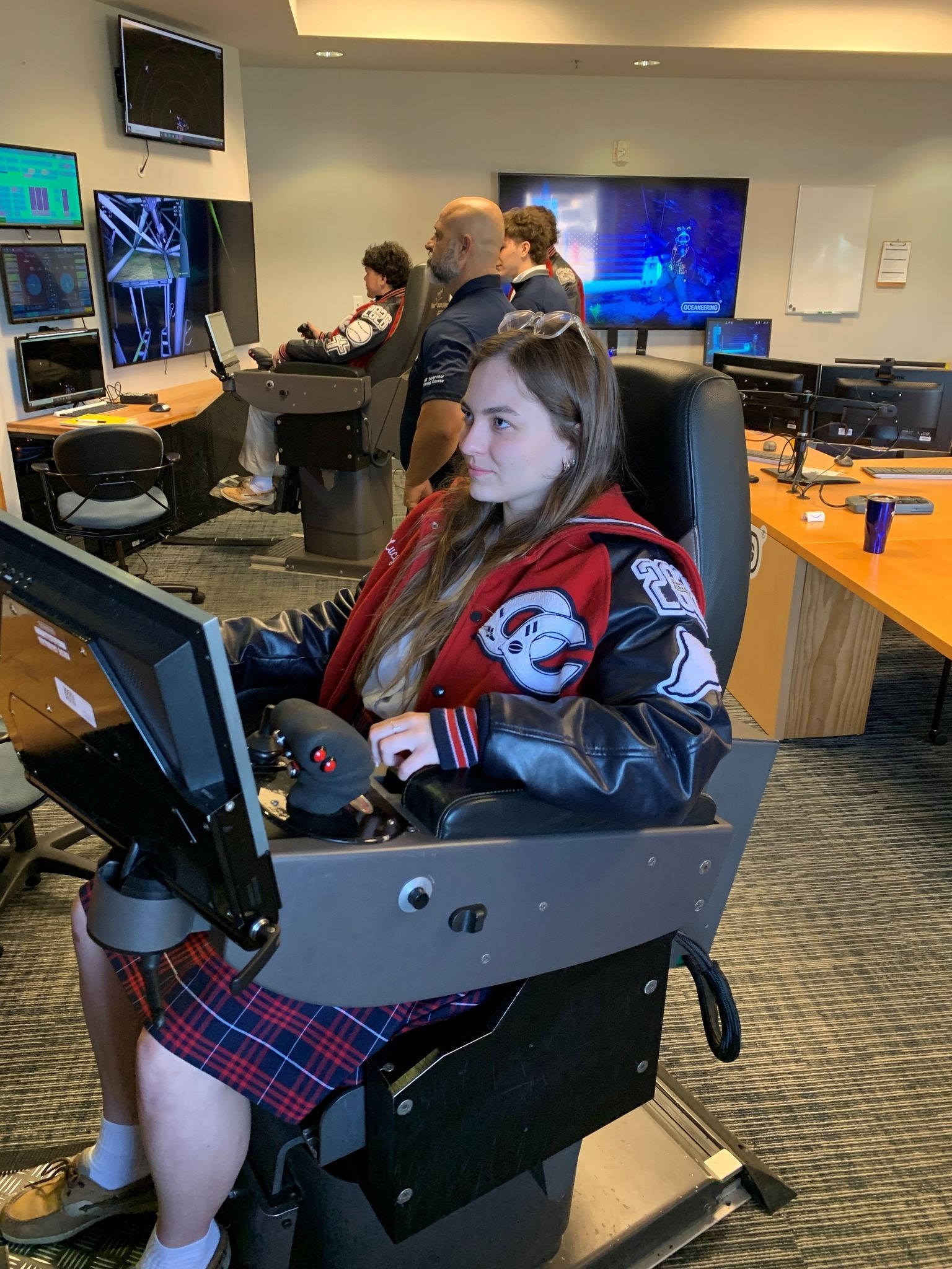 Three young boys wearing red shirts with the letter c on them