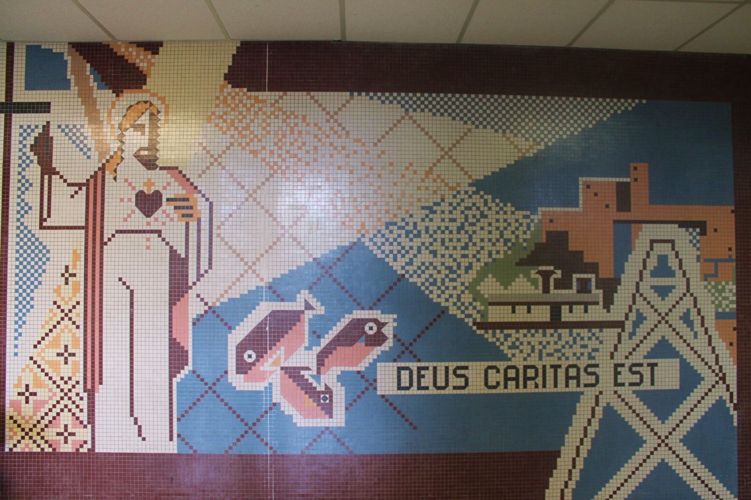 A mosaic of jesus and the words deus caritas est